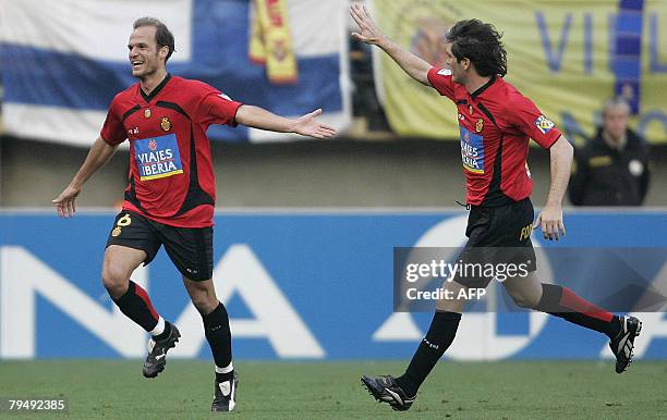 Mallorca's Angelos Basinas celebrates his goal against Villarreal with Hector Belenguer during a Spanish league football match at the Madrigal...