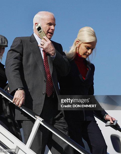 Republican presidential hopeful Arizona Senator John McCain and his wife Cindy arrive at Westchester County airport in White Plains, New York, 03...