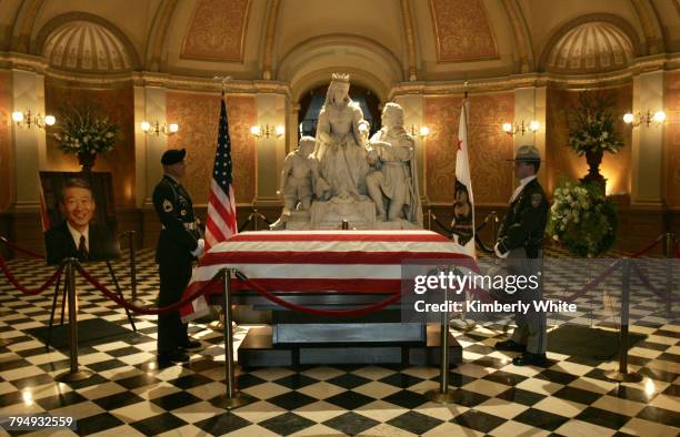 An Honor Guard, left, and California Highway Patrol officer, right, stand guard over the casket of Robert T. Matsui, a child of World War II...