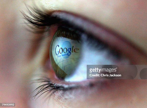 In this photo illustration the Google logo is reflected in the eye of a girl on February 3, 2008 in London, England. Financial experts continue to...