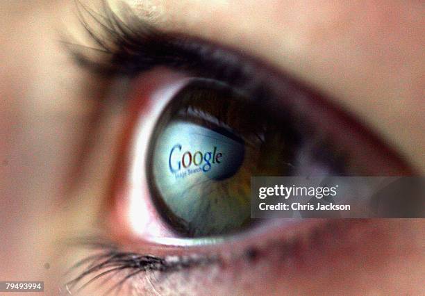 In this photo illustration the Google logo is reflected in the eye of a girl on February 3, 2008 in London, England. Financial experts continue to...