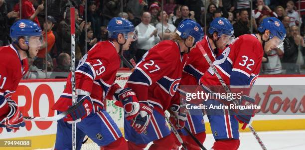 Saku Koivu, Andrei Markov, Alexei Kovalev, Christopher Higgins and Mark Streit of the Montreal Canadiens skate to the bench after a power play goal...