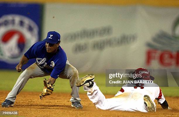 Anderson Hernandez of Dominican Republic's Tigres de Licey tags out Agustin Murillo of Yaquis of Mexico during their Caribbean Series game at the...