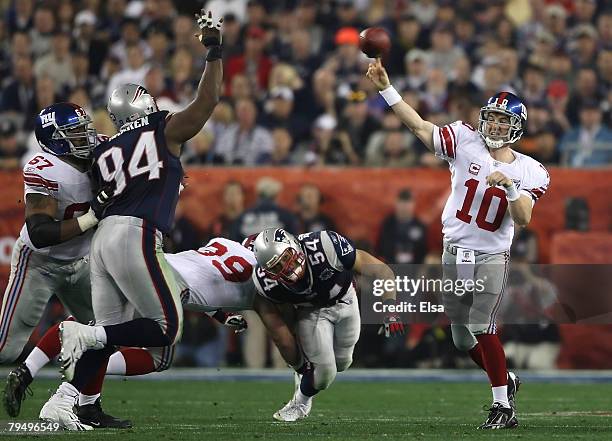 Quarterback Eli Manning of the New York Giants passes against the New England Patriots during Super Bowl XLII on February 3, 2008 at the University...