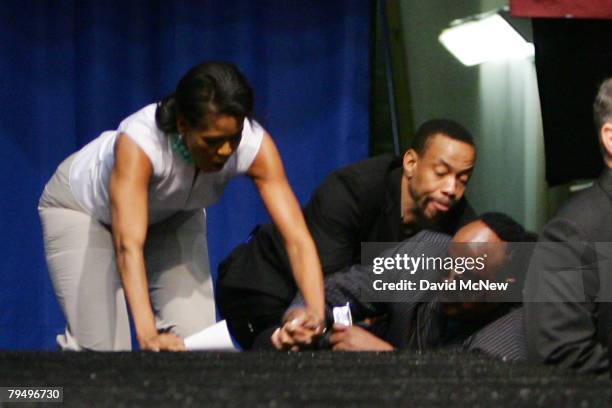 Musician Stevie Wonder falls while ascending backstage stairs with Michelle Obama, wife of Democratic presidential hopeful U.S. Sen. Barack Obama ,...