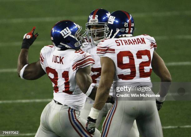 Osi Umenyiora Justin Tuck and Michael Strahan of the New York Giants celebrate against the New England Patriots during Super Bowl XLII on February 3,...