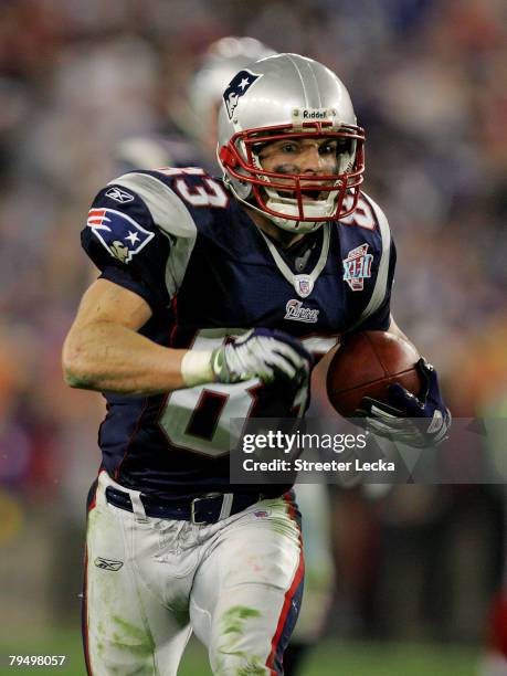 Wes Welker of the New England Patriots runs the ball in the fourth quarter of Super Bowl XLII against the New York Giants on February 3, 2008 at the...