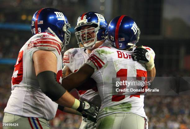 Wide receiver Plaxico Burress of the New York Giants celebrates after catching a 13-yard touchdown pass in the fourth quarter with teammates David...