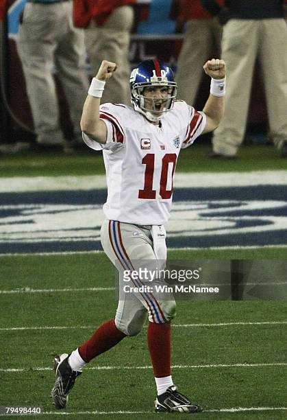 Quarterback Eli Manning of the New York Giants reacts after he threw a 13-yard touchdown pass to Plaxico Burress in the fourth quarter against the...