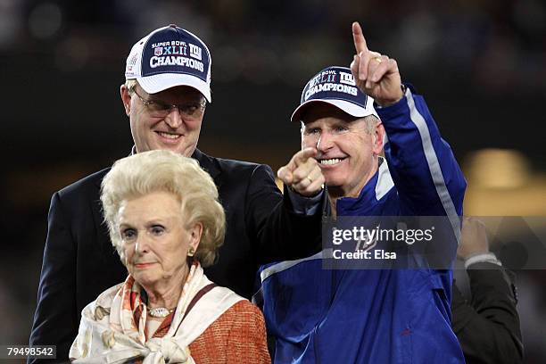 John K. Mara, president, CEO, and co-owner of the New York Giants, his mother Ann Mata and head coach Tom Coughlin react after the Giants defeated...