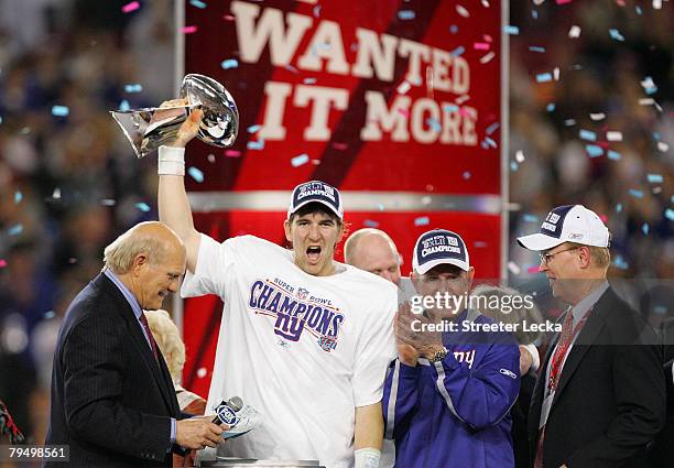 Quarterback Eli Manning of the New York Giants holds the Vince Lombardi Trophy after defeating the New England Patriots 17 0 14 after Super Bowl XLII...