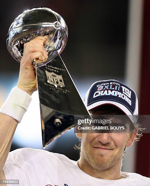 Quarterback Eli Manning of the New York Giants holds the Vince Lombardi Trophy after defeating the New England Patriots 17-14 in Super Bowl XLII at...