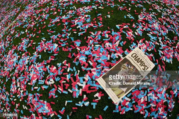 The front page paper is seen on a confetti strewn field after the New York Giants reacts defeated the New England Patriots 17-14 during Super Bowl...