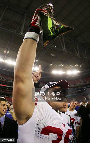 Madison Hedgecock of the New York Giants holds the Vince Lombardi Trophy after defeating the New England Patriots 17-14 in Super Bowl XLII on...