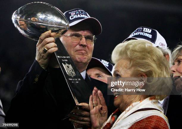 John K. Mara, president, CEO, and co-owner of the New York Giants, his mother Ann Mata hold the Vince Lombardi trophy after the Giants defeated the...