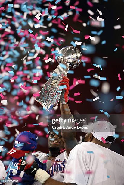 Wide receiver Plaxico Burress of the New York Giants holds the Vince Lombardi Trophy after defeating the New England Patriots 17-14 in Super Bowl...