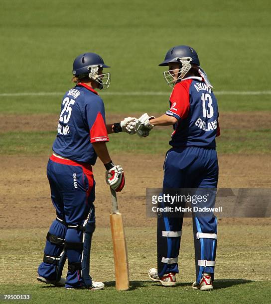 Nicola Shaw and Caroline Atkins of England encourage each other between overs during the Women's One Day International match between the Australian...