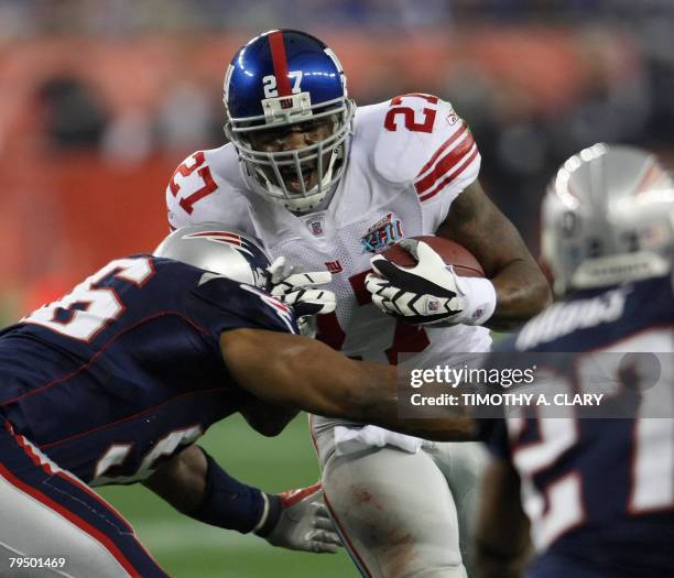 Brandon Jacobs of the New York Giants runs with the ball during Super Bowl XLII against the New England Patriots at the University of Phoenix Stadium...