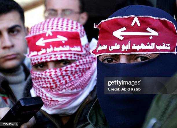 Masked gunmen attend a press conference while Abu Thaer a Palestinian spokesman of the Al-Aqsa Brigades the military wing of the Palestinian...