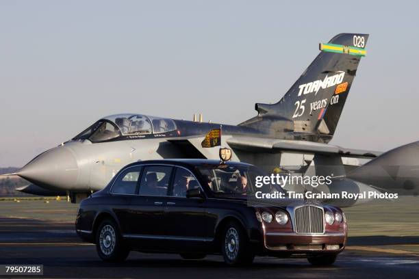 Queen Elizabeth II arrives by Rolls Royce, passing a Tornado jet plane, for an official visit to RAF Marham on February 4, 2008 in Norfolk, England....