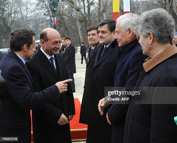 France's President Nicolas Sarkozy introduces members of the French delegation to Romania's President Traian Basescu in Bucharest, on February 4...