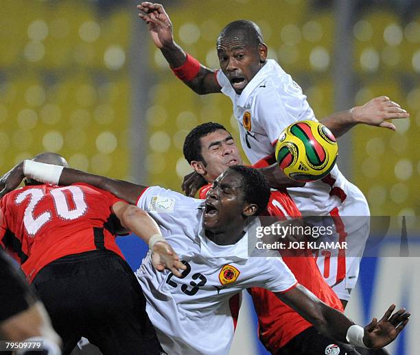 Egypt's Ahmed Fathi is tackled by Angola's Mateus Alberto Contreiras Goncalves and Felisberto 'Gilberto' Amaral during a quarter-final match between...