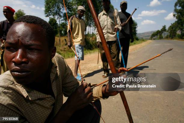 Kalegins tribe member watches for the rival tribes with his bow and arrow February 4, 2008 in Sotik, Kenya. Sparked by December's disputed elections,...