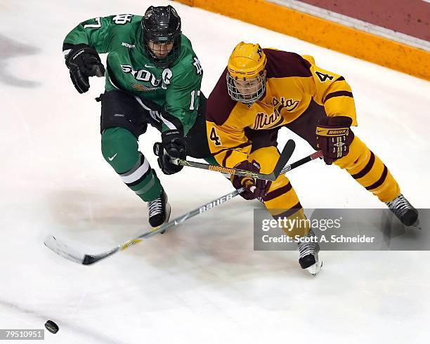 Rylan Kaip of the University of North Dakota Sioux and Stu Bickel of the University of Minnesota Gophers chase a loose puck February 1, 2008 at...