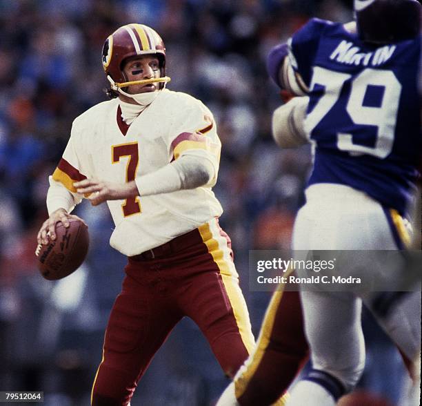 Joe Theismann of the Washington Redskins back to pass during the NFL Playoff Game against the Minnesota Vikings on January 15,1984 in Washington,...