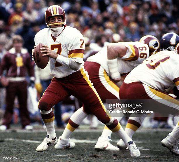 Joe Theismann of the Washington Redskins back to pass during the NFL Playoff Game against the Minnesota Vikings on January 15,1984 in Washington,...