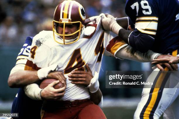 John Riggins of the Washington Redskins carries the ball during the NFL Playoff Game against the Minnesota Vikings on January 15,1984 in Washington,...