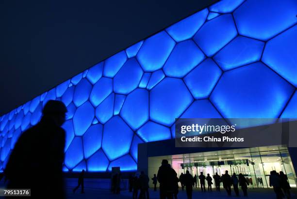 Spectators walk into the National Aquatics Centre, dubbed the "Water Cube" to watch the 'Good Luck Beijing' World Swimming China Open, on February 4,...