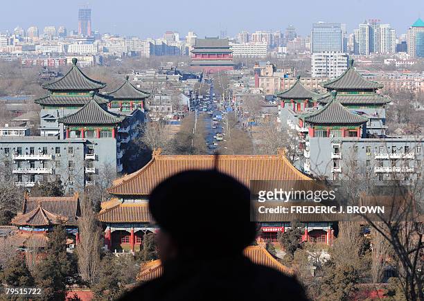 By Charles Whelan A man takes in the view of central Beijing from the top of Coal Hill, or Jingshan Park, looking northward along the former imperial...