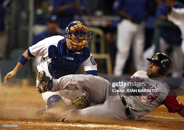 Matt Tupman of Tigres del Licey of Dominican Republic makes an out in home plate to Victor Diaz of Aguilas del Cibao, also of Dominican Republic,...