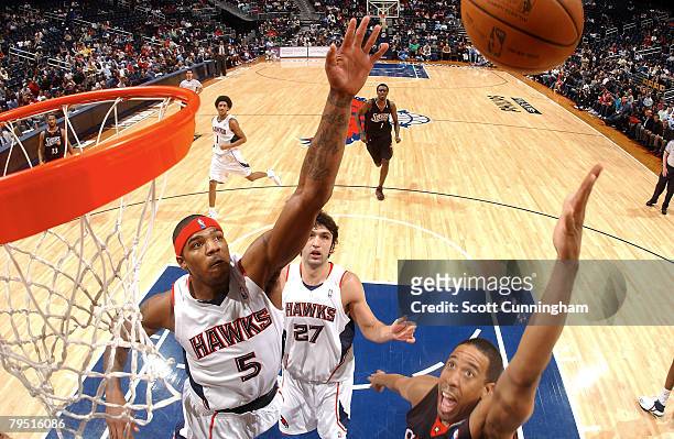 Josh Smith of the Atlanta Hawks goes up for one of his nine blocked shots against Andre Miller of the Philadelphia 76ers at Philips Arena on February...
