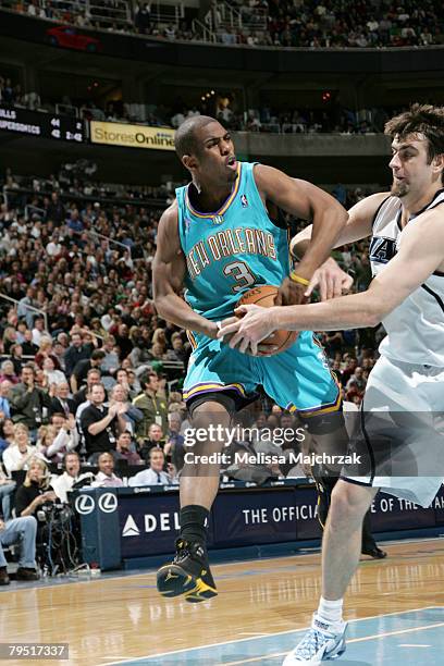 Mehmet Okur of the Utah Jazz ties up Chris Paul of the New Orleans Hornets at EnergySolutions Arena on February 4, 2008 in Salt Lake City, Utah. NOTE...