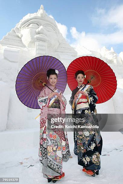 Miss Tokamachi, Akiko Suga and Mayumi Ota pose in front of the snow sculptures "Relics of Egypt" prepared for Sapporo Snow Festival 2008 at Odori...