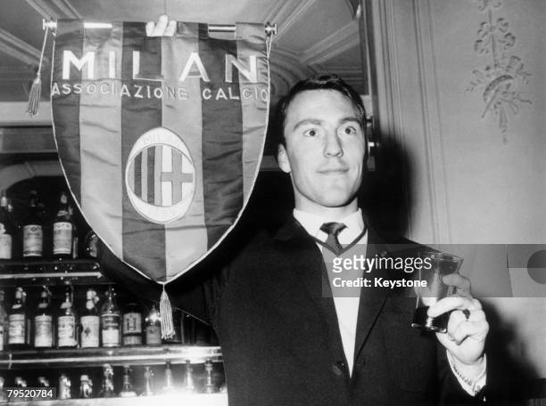 Chelsea striker Jimmy Greaves holds up an AC Milan pennant during a visit to the club in Milan before his transfer to the Italian side, 2nd May 1961.