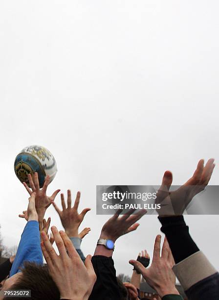 Residents take part in the annual Shrovetide football match in Ashbourne, in Derbyshire, central England, February 5, 2008. The game dates back to...