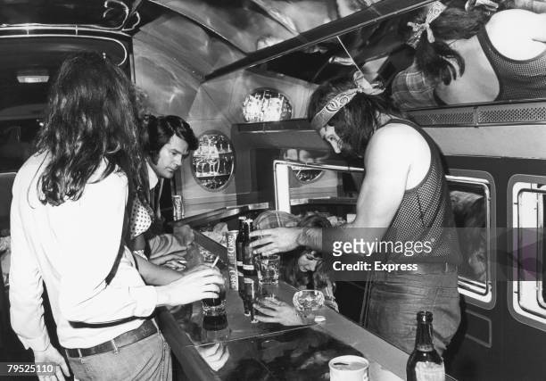 Express reporter Colin McKenzie at the bar on board a private Boeing 720B airliner known as 'The Starship', which is being used by English rock group...
