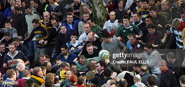 Residents take part in the annual Shrovetide football match in Ashbourne, in Derbyshire, central England, February 5, 2008. The game dates back to...