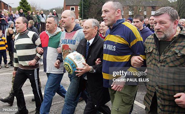 Residents take part in the annual Shrovetide football match in Ashbourne, in Derbyshire, central England, February 5, 2008. The game dates back to...