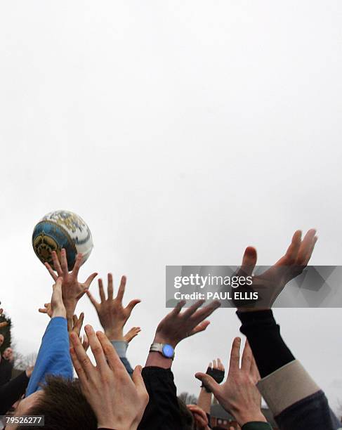 Residents take part in the annual Shrovetide football match in Ashbourne, in Derbyshire, central England, February 5, 2008. The game dates back to...