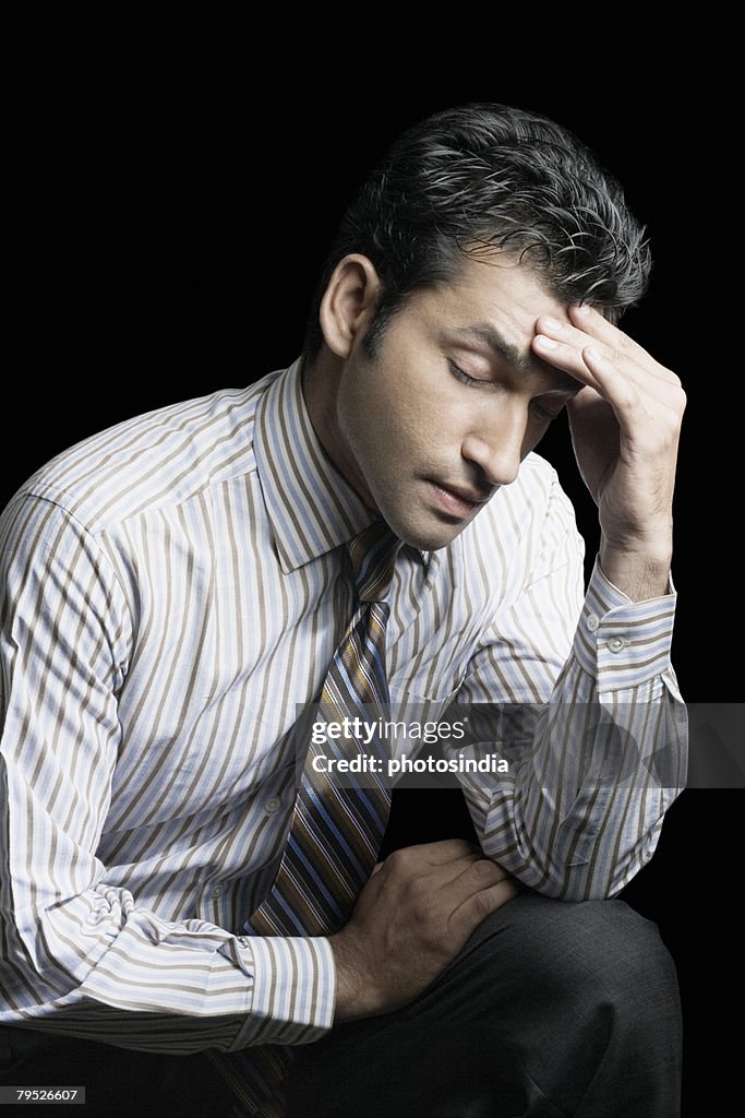 Close-up of a businessman suffering from a headache