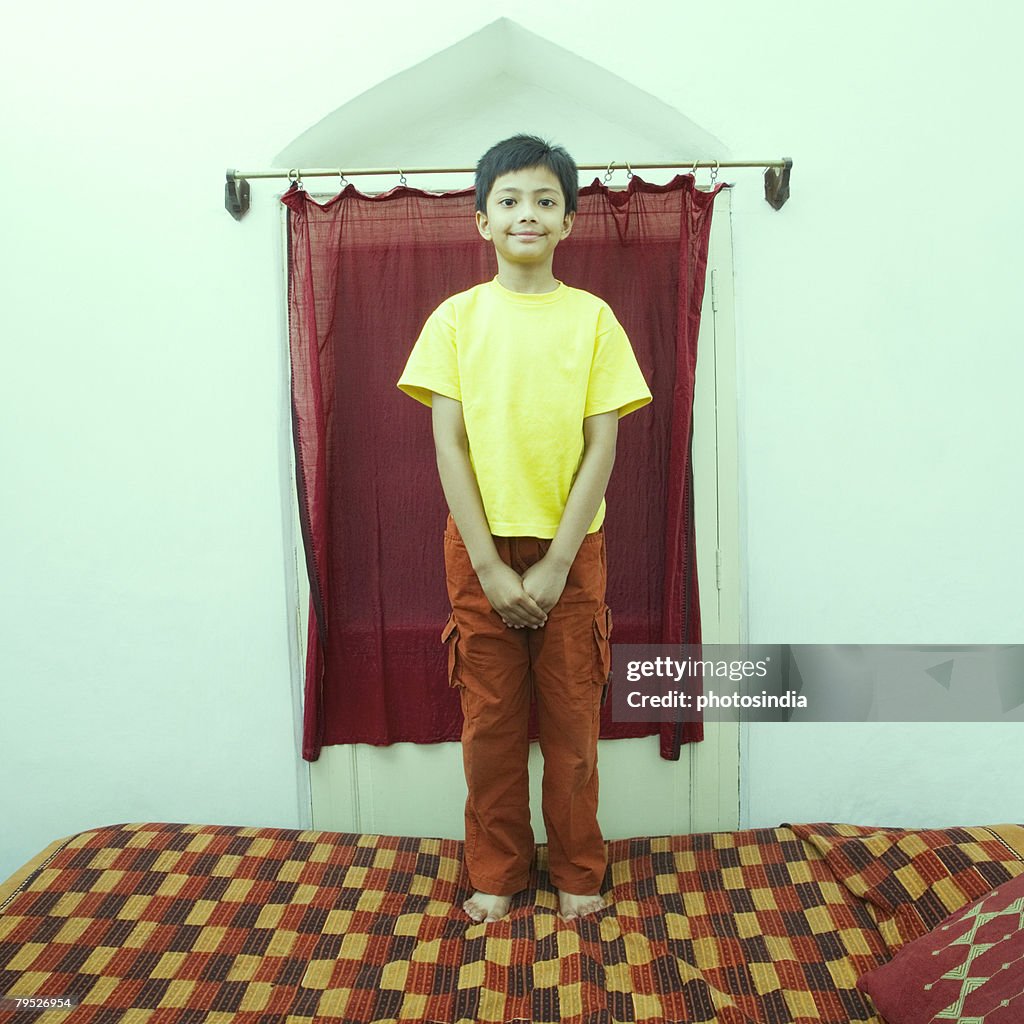 Portrait of a boy standing and smiling