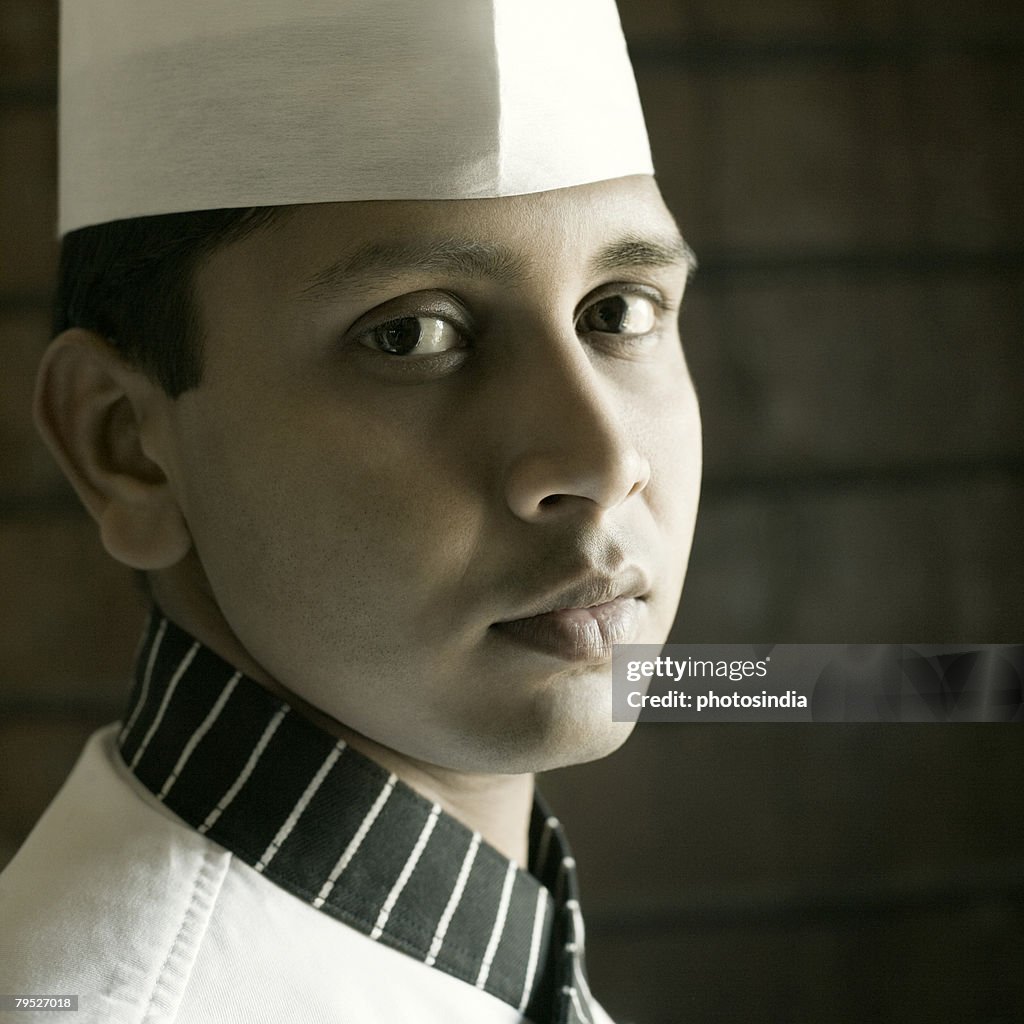 Portrait of a chef in front of a brick wall