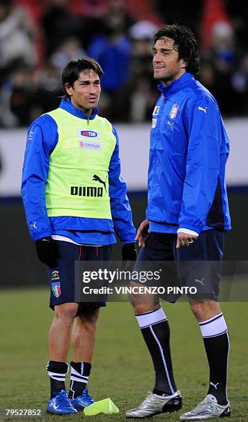Italian striker Marco Borriello smiles to teammate Luca Toni during a training session at Zurich Letzigrund stadium on February 5, 2008. Italy will...