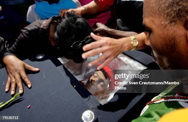 Relatives bid farewell overthe coffin of Tata Guines during the funeral of Frederico "Tata Guines" Aristides Soto, Feburary 5, 2008. In Guines, Cuba....