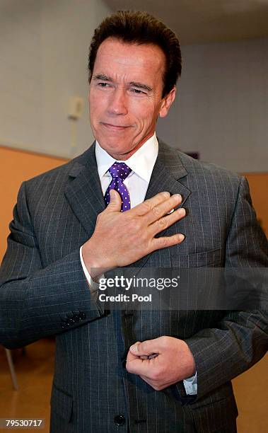 Governor Arnold Schwarzenegger applies his "I voted" sticker at Kenter Canyon Charter Elementary School February 5, 2008 in Los Angeles, California....