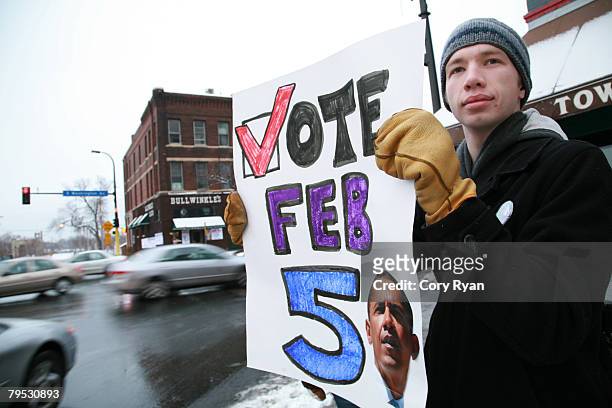 Matt Kokotovich a student at the University of Minnesota and a U.S. Sen. Barack Obama volunteer, shows his support by holding a caucus sign along...